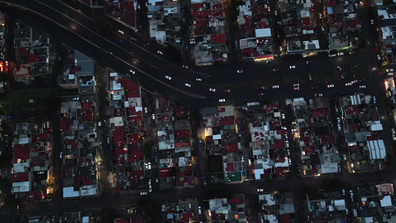 Drone descends over a residential area in Ecatepec as night falls