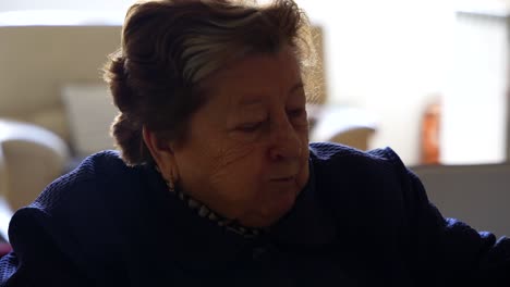 Close-up-of-old-woman-eating-healthy-piece-of-apple