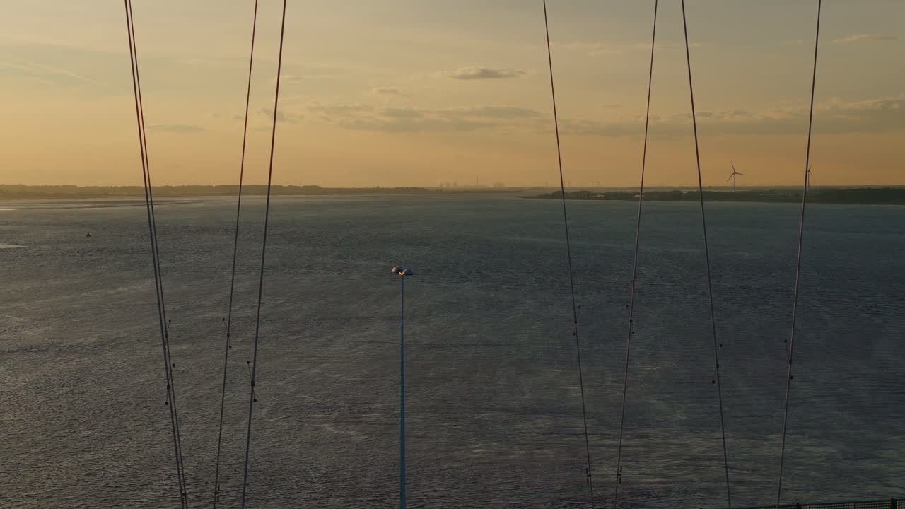 Sunset's canvas: Aerial view of Humber Bridge with cars creating a tranquil panorama
