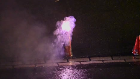 a firework has been lit and begins to produce smoke and warm colors during a swiss party