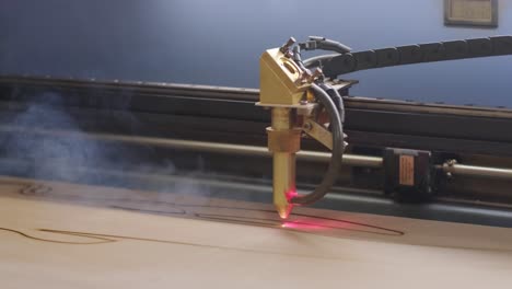 cnc laser cutting machine cuts wooden plank and plywood