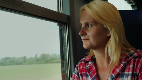 woman looks out of train window