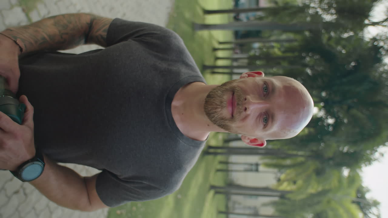 Portrait of Sportsman with Water Bottle in Park on Summer Day
