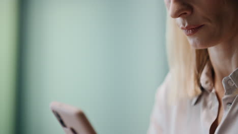 Woman-fingers-messaging-mobile-phone-indoors-closeup.-Person-typing-telephone