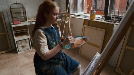 artist painting on a canvas