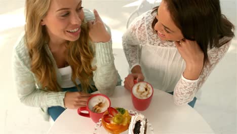 Pretty-girl-talking-with-macchiato-and-desserts