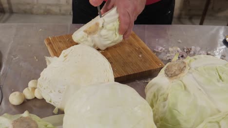 cutting out cabbage root on table with garlic