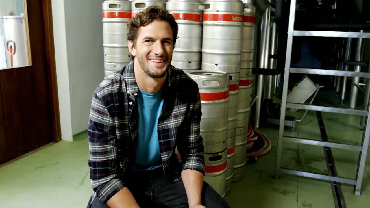 Brewer testing beer at brewery factory 4k