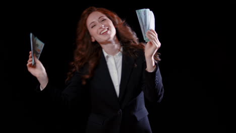 -A-caucasian-businesswoman-dancing-with-money