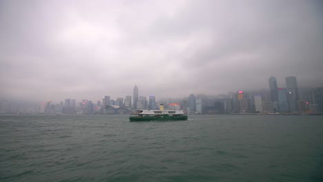 ferry in front of hong kong skyline