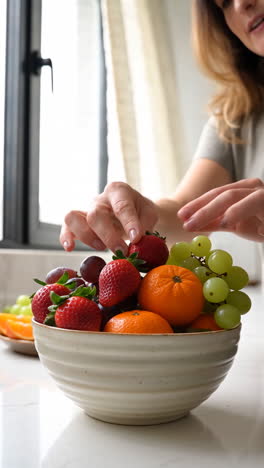 Woman Arranging a Fresh Fruit Bowl