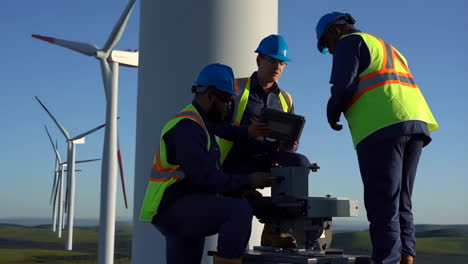 engineers working on a wind turbine at a wind farm