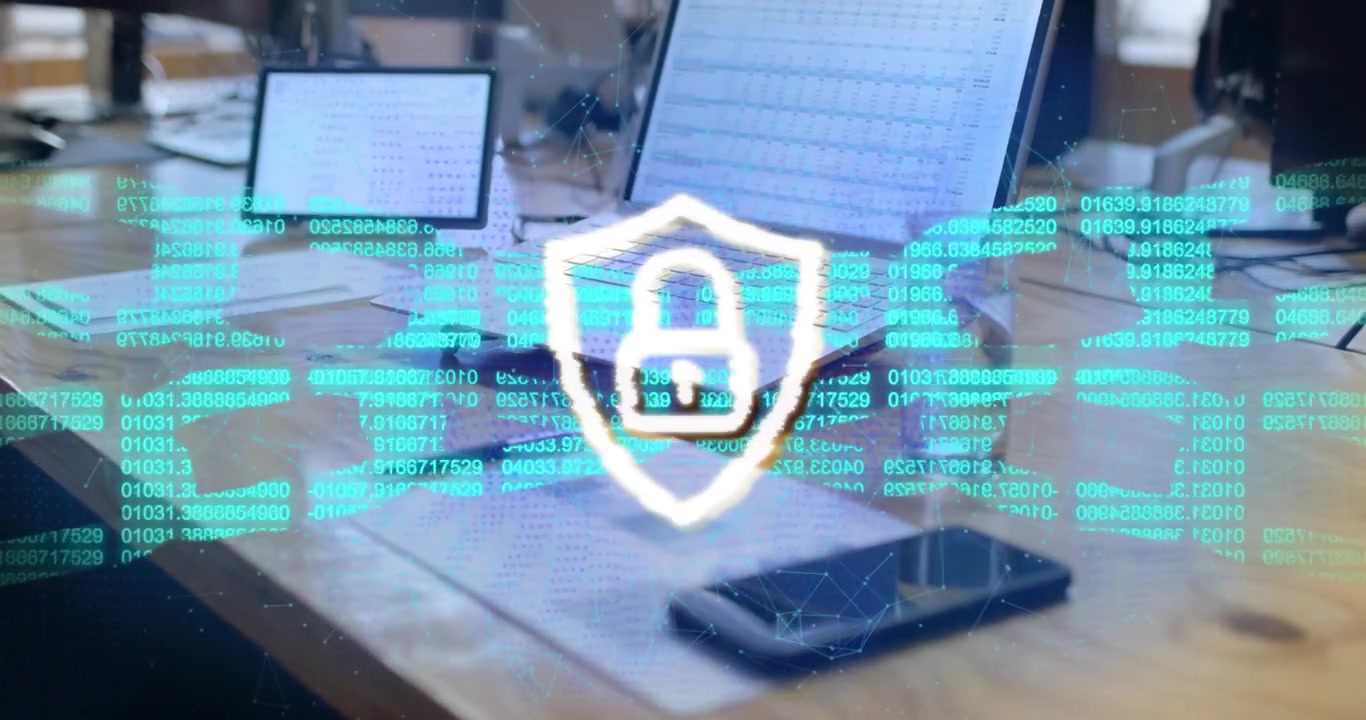 Opening desk showing devices with scrolling code forming sphere, pulsing shield showing security
