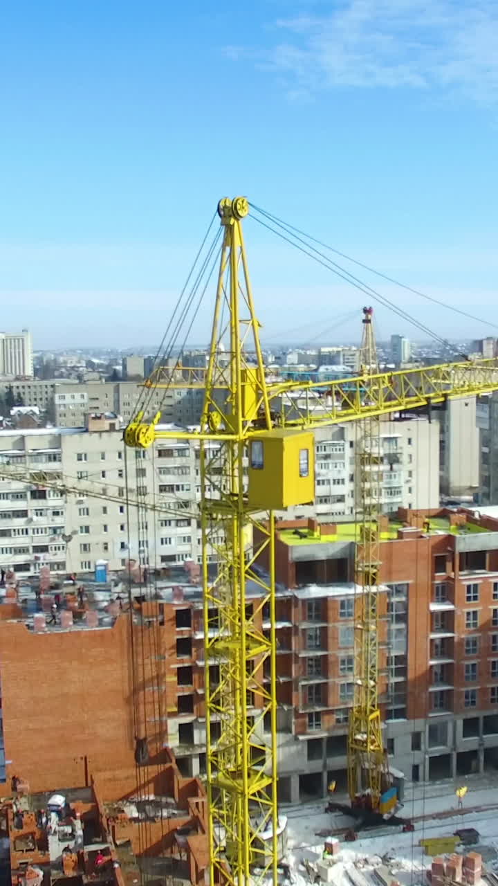 Construction of building in winter. Tall buildings under construction with cranes