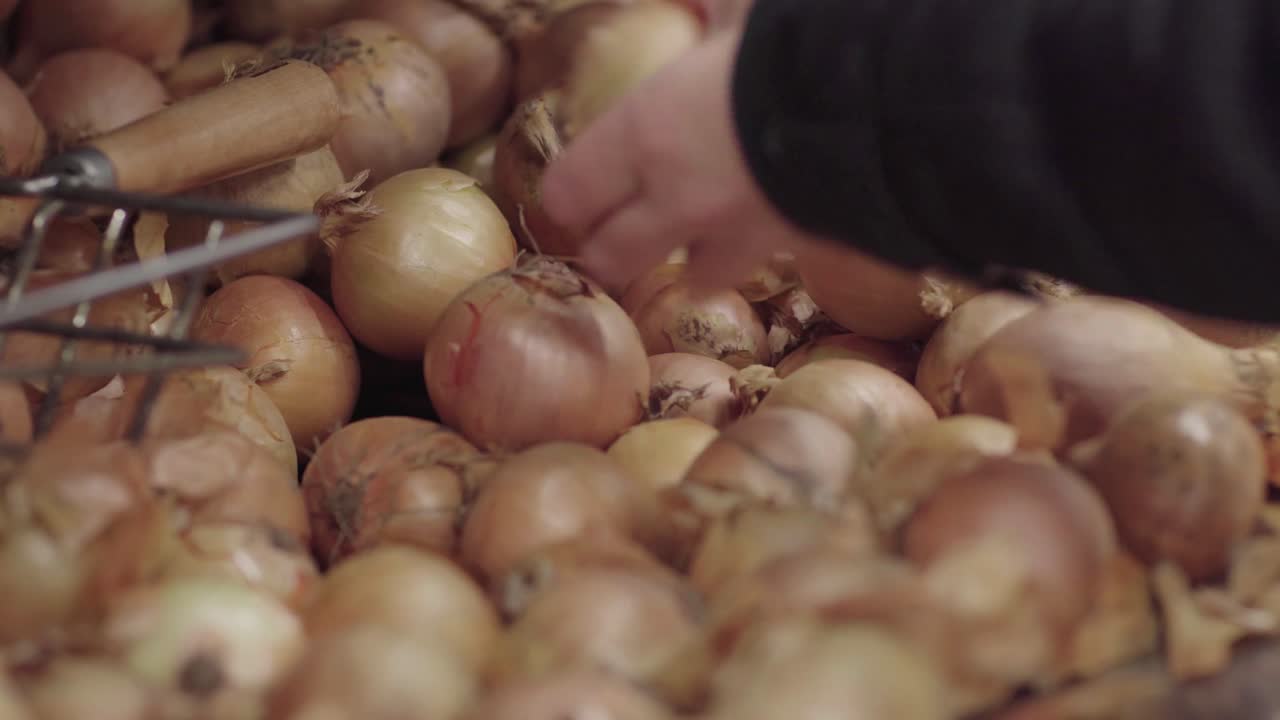 Picking an onion from a pile of onions