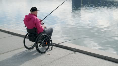 person with a physical disability who uses wheelchair fishing from fishing pier