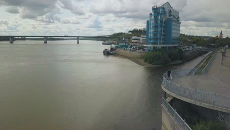 just-married-couple-on-viewpoint-over-large-river-upper-view