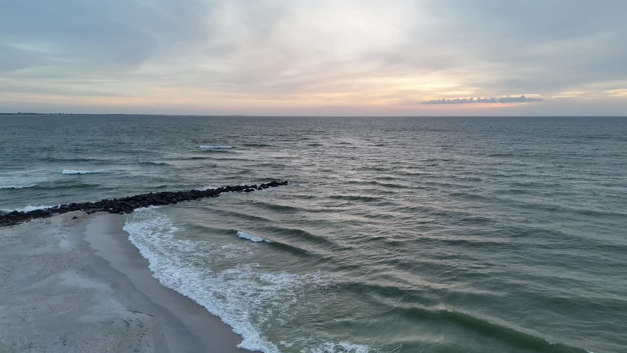 Onde che si infrangono sulla costa di St. Pete Beach al tramonto.