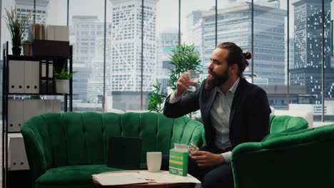 Vertical Video Concerned CEO taking an aspirin to ease the headache due to stress