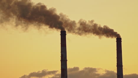 Air pollution. Grey smoke from pipes of metallurgy plant. Toxic emissions filling the environment from industrial pipes badly affecting life. Ecological disaster.