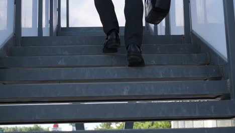 businessman walking up stairs with briefcase