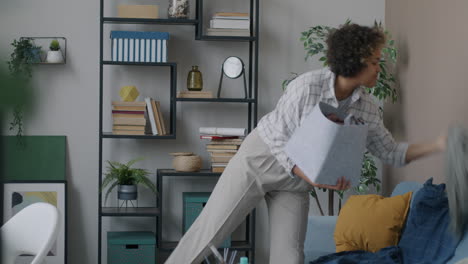 woman carrying laundry basket in living room