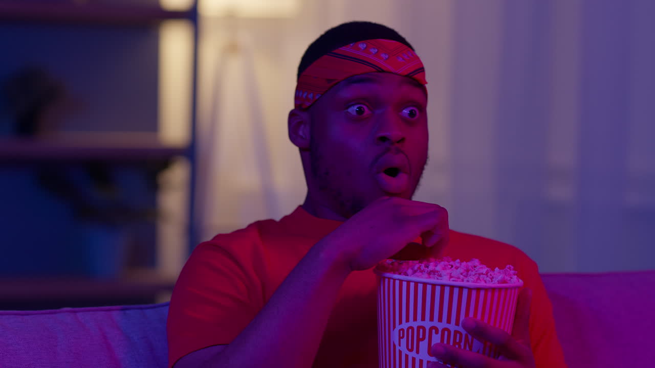 Man Watching a Movie with Popcorn, Surprised