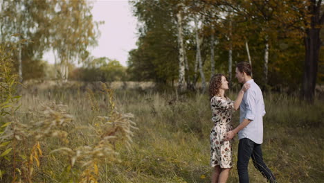 Loving-Couple-Walking-On-A-Meadow-In-Summer-15