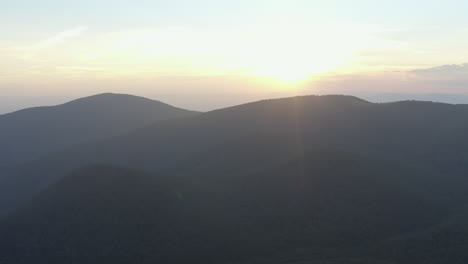 an aerial shot of cole mountain seen from the mount pleasant summit during a summer evening