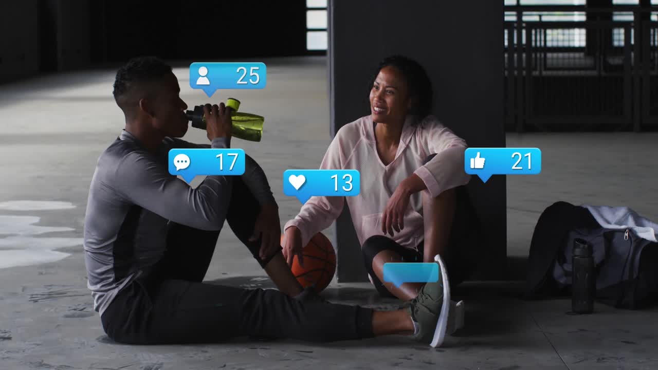 Animation of notification icons over african american woman talking with man drinking water in gym
