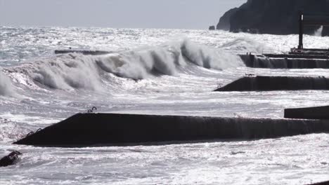 powerful waves crashing against breakwaters