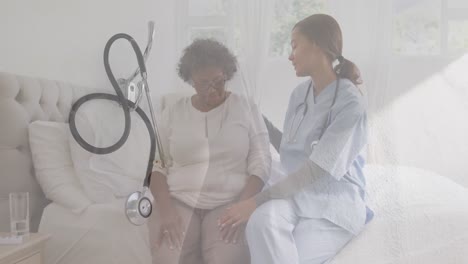 animation of stethoscope over female doctor with senior woman sitting on bed