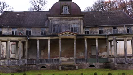 entrance of and old scary manor on a gloomy day, burtnieki, latvia