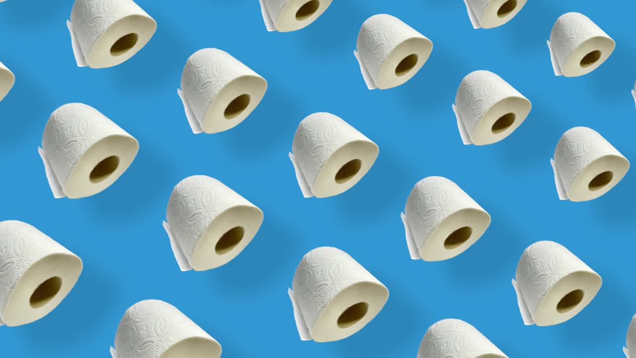 Colorful pattern of rolls of a white toilet paper isolated on blue background with shadows. Seamless pattern with toilet paper. Top view. Realistic animation. 4K video motion