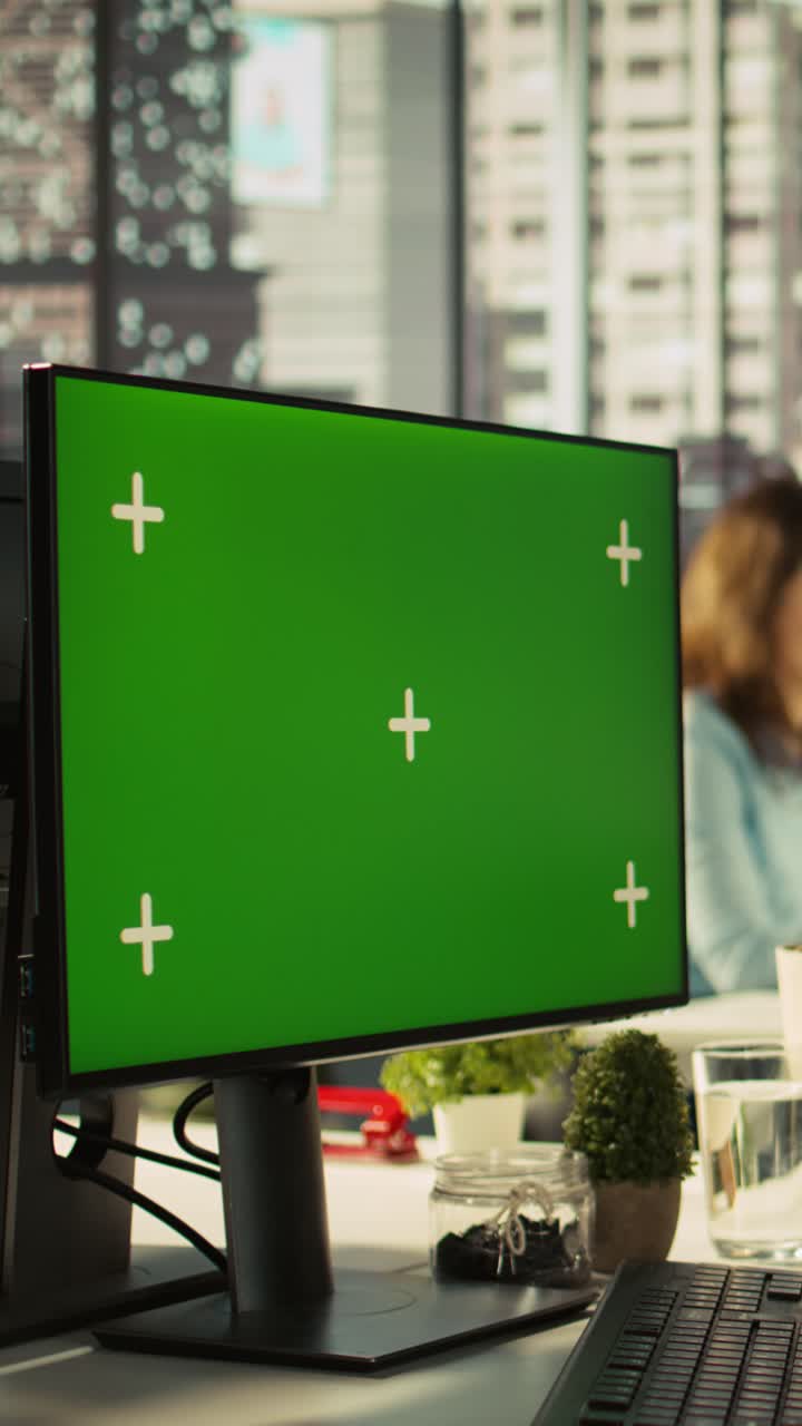 Vertical video Man in office reviewing financial graphs on green screen PC