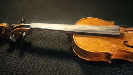 slow pan across the honey body of a classic violin