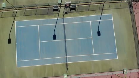 general view of empty green tennis court with lines and net