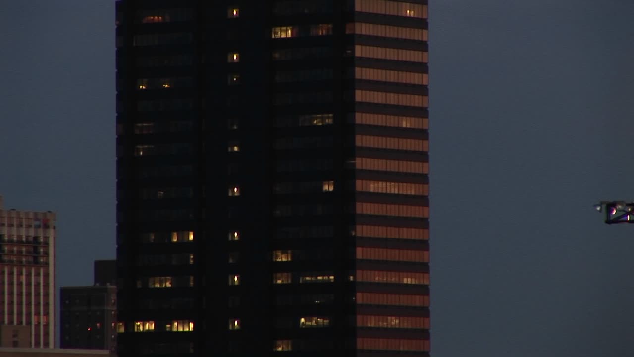 The Camera Pans Up A Skyscraper Topped With A Revolving Marquee Announcing Stock Market And Other News Of The Day