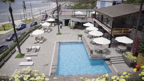 unique resort in peru and swimming pool with white umbrellas near sea, peru