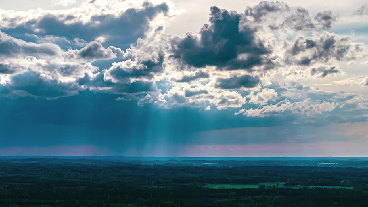 Cumulus stratocumulus clouds sunbeams breaking through creating a dramatic effect timelapse