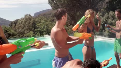 Happy-friends-doing-water-gun-battle