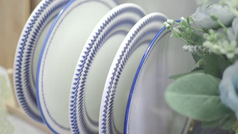 stack of decorative plates and floral arrangement