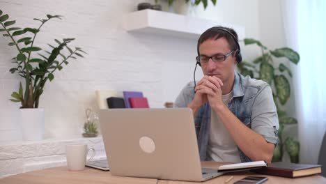 thoughtful serious young man student writer sit at home office desk with laptop thinking of inspiration search problem solution ideas lost in thoughts concept dreaming looking away