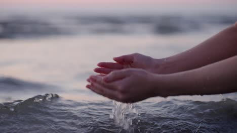 collecting water with hands in the sea