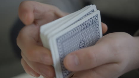 Close-up-shot-man-shuffling-deck-of-playing-cards-poker-shuffle-hands-only