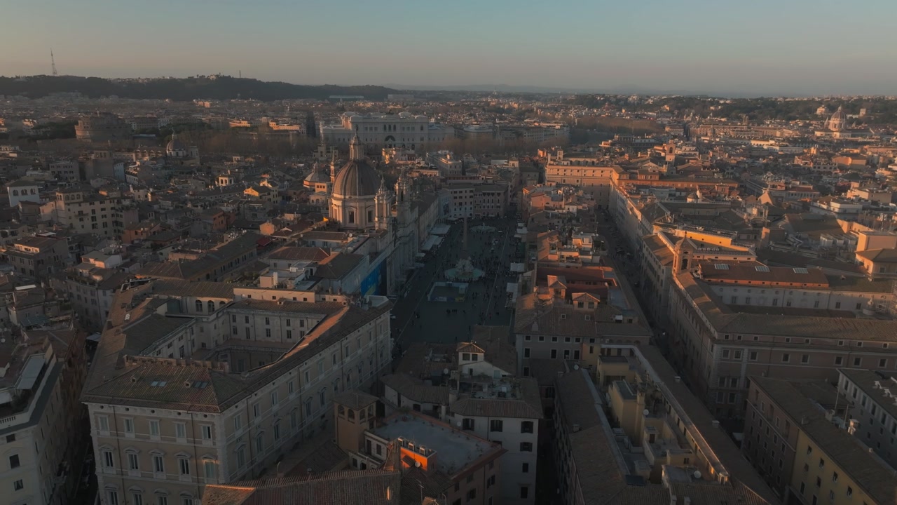 Stunning aerial shot of Piazza Navona in Rome during golden hour, showcasing historic Italian architecture and city landmarks.