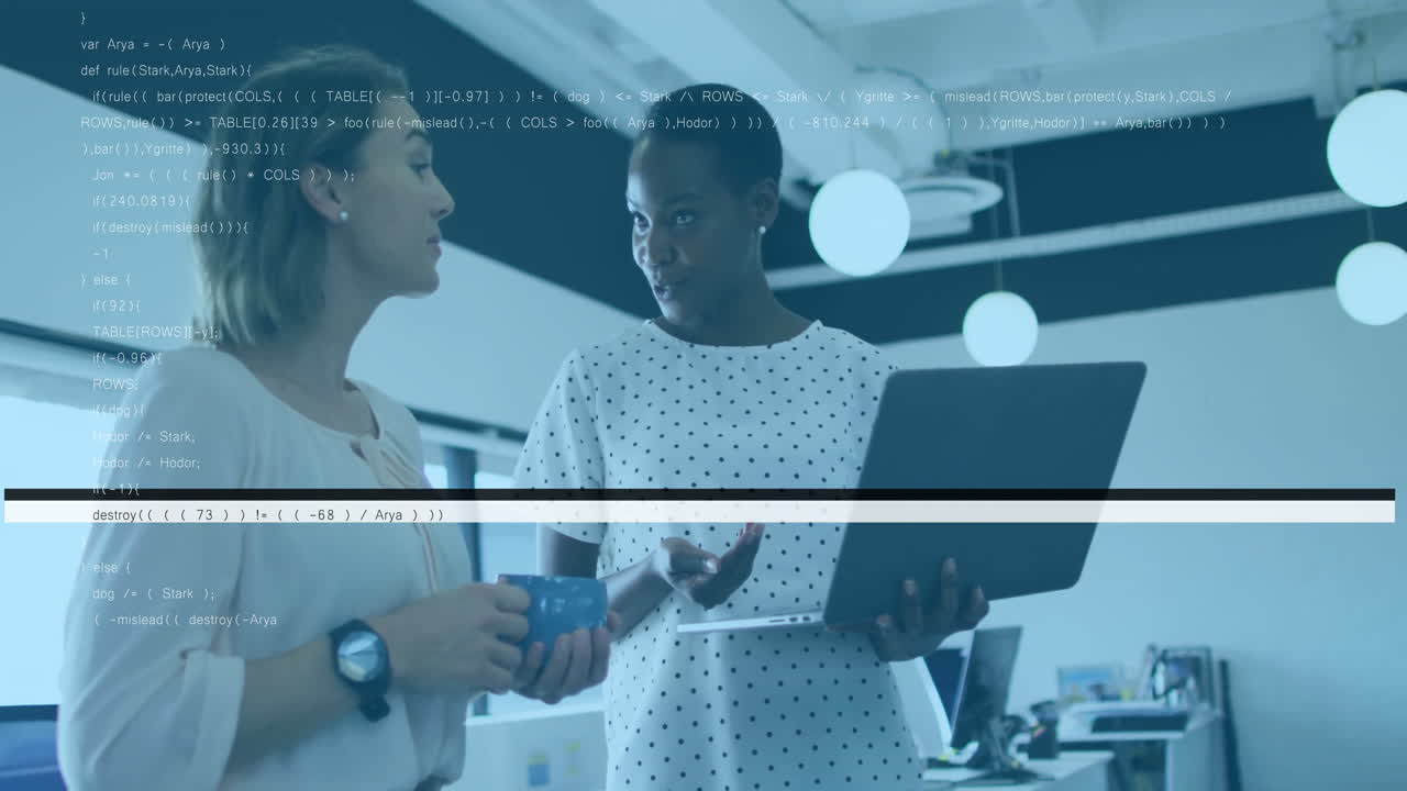 Two female colleagues discussing data on laptop in modern open-plan office, with animated charts