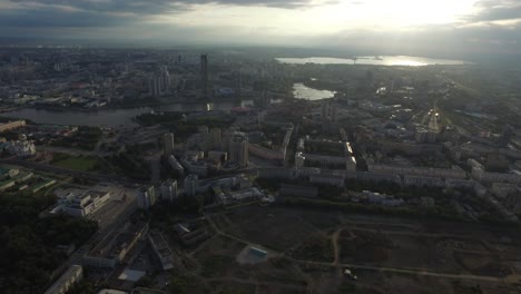 aerial view of a city by the river at sunset