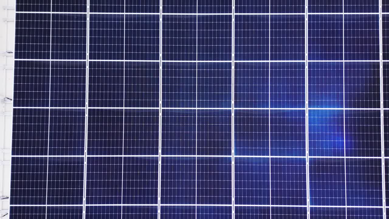 Extreme close-up of crystalline photovoltaic cells forms blue geometric grid, ideal tech background for renewable themes. Drone Top View. Drone Aerial Lombardy, Italy Lombardia, Italia