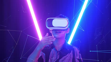 vr, futuristic, entertainment concept. excited asian boy using virtual reality headset and use hand slide with neon light at the background